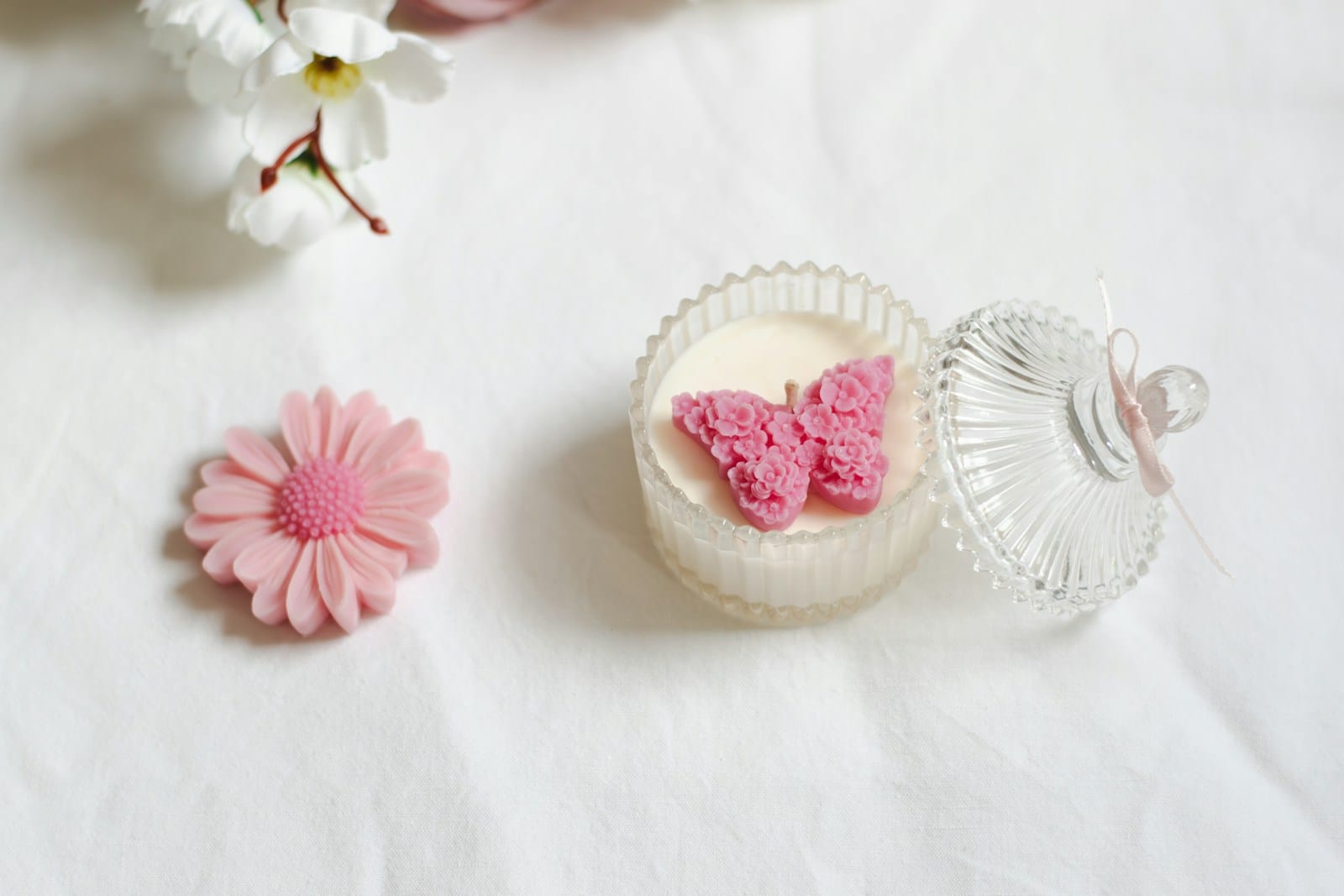 A white table topped with pink and white flowers